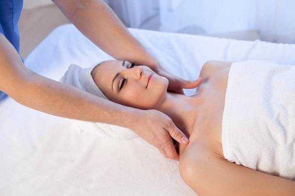 doctor cosmetologist doing facial massage girl spa treatments - Valokuva, kuva