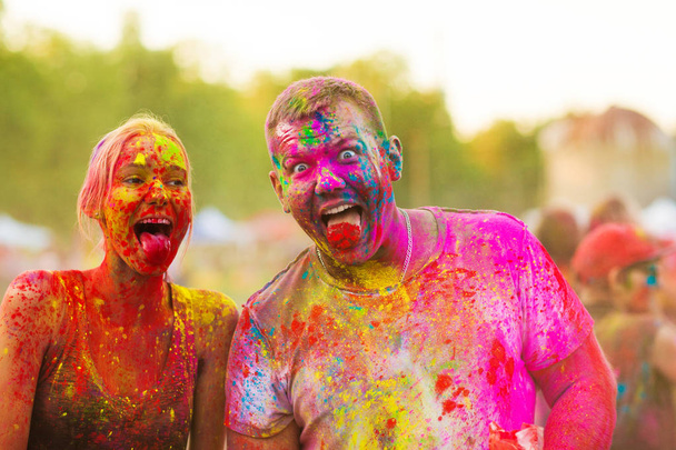 Guys with a girl celebrate holi festival - Фото, изображение