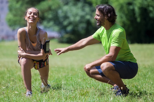 Young couple having training in the park on a sunny day - Fotoğraf, Görsel
