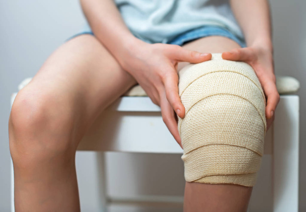 Child knee with elastic bandage on it. - Photo, Image