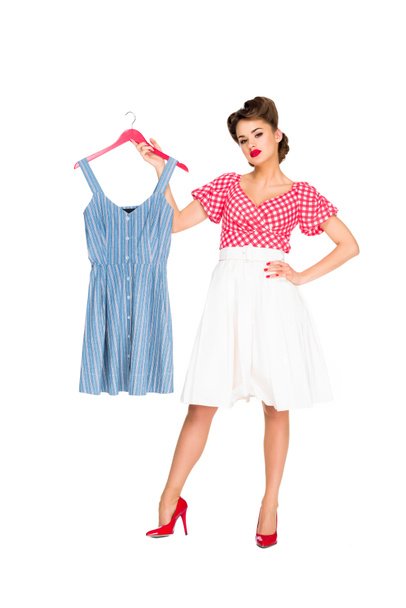 stylish woman in retro clothing holding dress on hanger isolated on white - 写真・画像