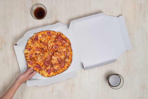 Pizza in a cardboard box. Space for text. View from above. Pizza delivery. Pizza menu.  - Photo, Image