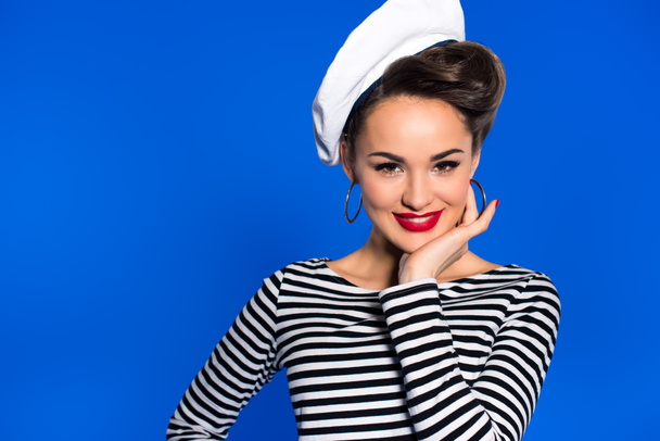 beautiful young woman in sailor shirt isolated pn blue - Foto, imagen