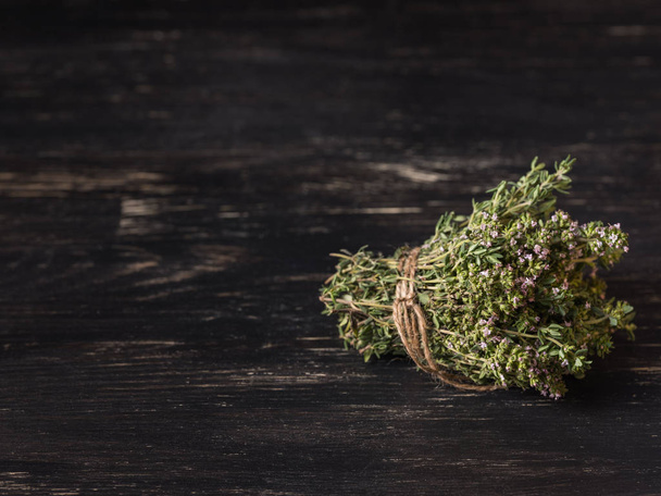 close-up of green dry herbs on black wooden table - Photo, image