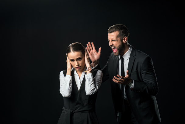 angry boss yelling at businesswoman, isolated on black - Photo, Image