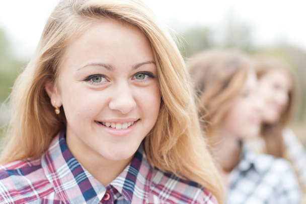 Young happy teen girl with friends - 写真・画像
