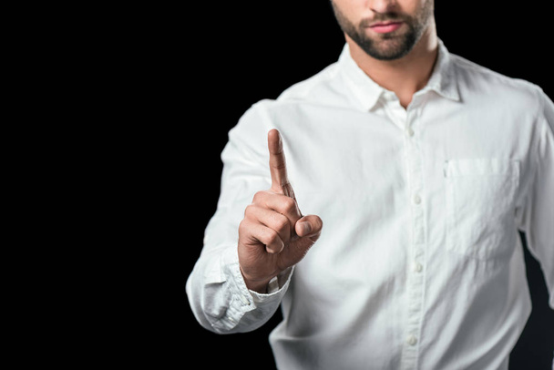 cropped view of businessman pointing up, isolated on black - Foto, imagen