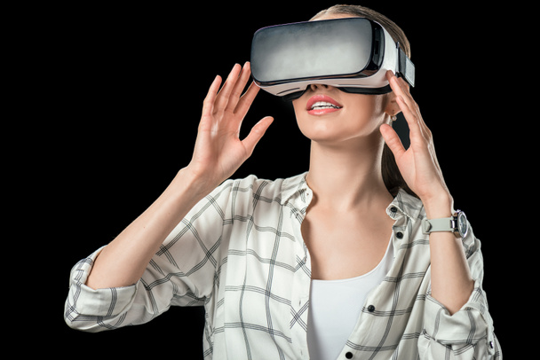woman using virtual reality headset, isolated on black - Photo, Image