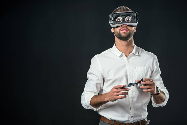 man using virtual reality headset, isolated on black - Foto, Bild