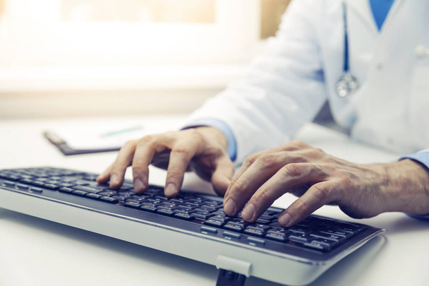 doctor typing on computer keyboard in office. online consultation - Photo, Image