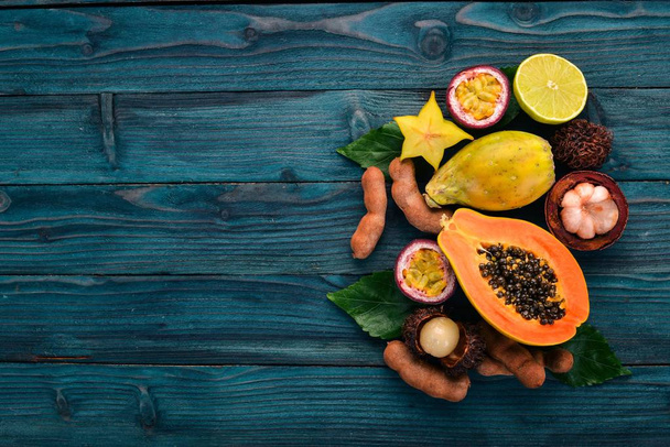 Papaya, mangosteen, maracuya, cactus fruit. Fresh Tropical Fruits. On a wooden background. Top view. Copy space. - Fotó, kép