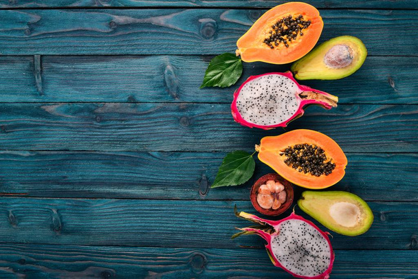 Dragon Fruit, Avocado, Papaya and Mangosteen. Tropical Fruits. On a wooden background. Top view. Copy space. - Fotografie, Obrázek
