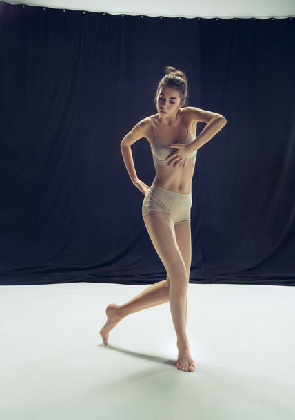 Young teen dancer ion white floor background. - Valokuva, kuva