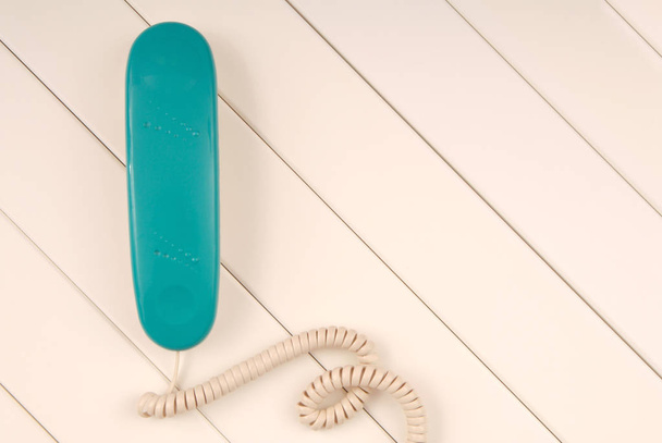 home telephone is on white background, green phone device is on  - Фото, изображение