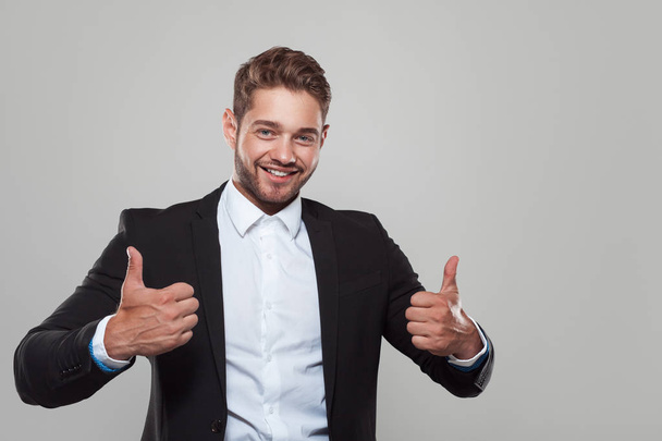 Content businessman showing thumbs up - Фото, изображение