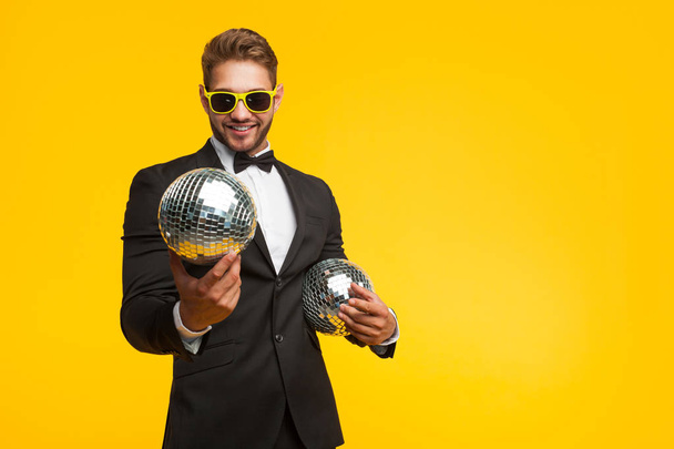 Young man in suit with disco balls - Fotoğraf, Görsel