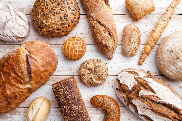 Delicious fresh bread on wooden background - Φωτογραφία, εικόνα