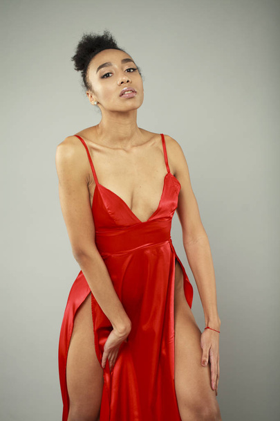 Portrait of sensual young african woman in red dress - Foto, afbeelding