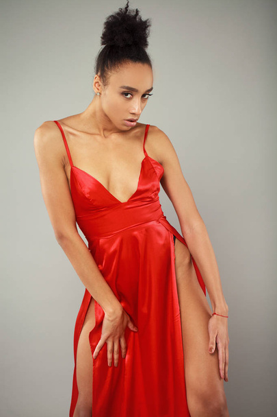 Portrait of sensual young african woman in red dress - 写真・画像