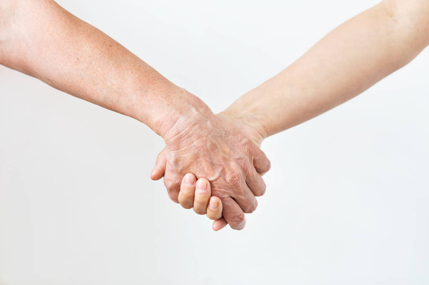 close up of senior and young woman holding hands - Foto, Bild