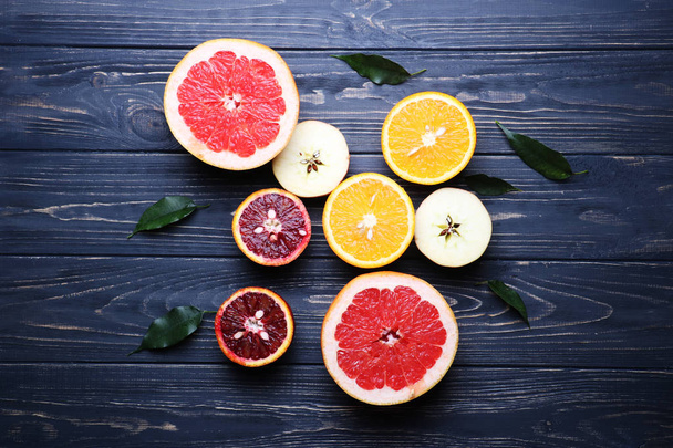 Sliced citrus fruits, vitamins, oranges, grapefruits, lemons, apples,  juicy fruits background - Photo, Image