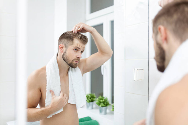 Handsome young man worried about hairloss - Fotografie, Obrázek
