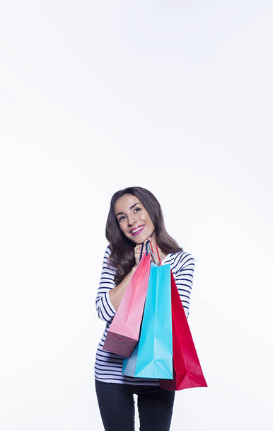 Sale concept. Shopping smiling beautiful woman holding colored shoping bags in casual clothes isolated on white background. Black friday holiday - Φωτογραφία, εικόνα