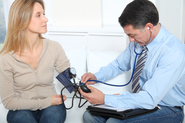 Doctor measuring blood pressure - Foto, Bild