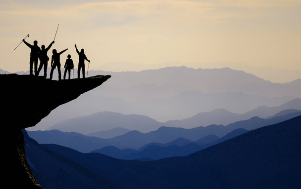 Silhouette of team on the mountain top. Sport and active life - Photo, Image