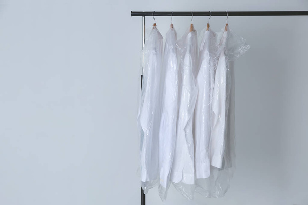 Rack with clean shirts in laundry - Foto, afbeelding