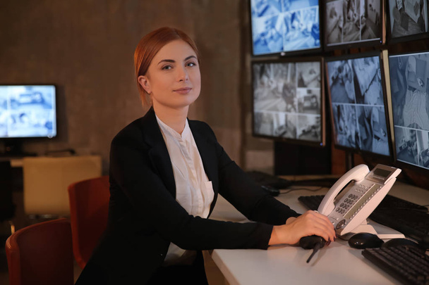 Female security guard working in surveillance room - Photo, Image