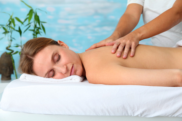 Closeup of beautiful blond woman on a massage bed - Фото, изображение