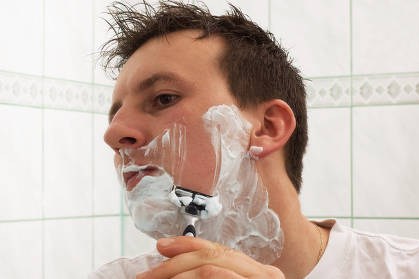 Young man is shaving - Photo, Image