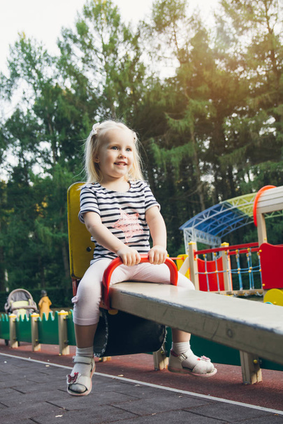 Little girl having fun on the Playground  - Фото, изображение