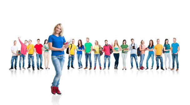Large group of teenage students with books and backpacks standing together over white background. School, education, college, university concept. Girl at the forefront holding copybooks - Photo, Image