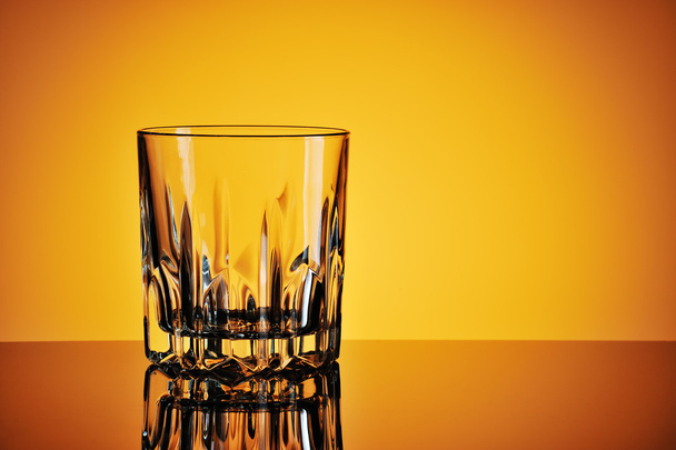 Empty glass against yellow background - 写真・画像