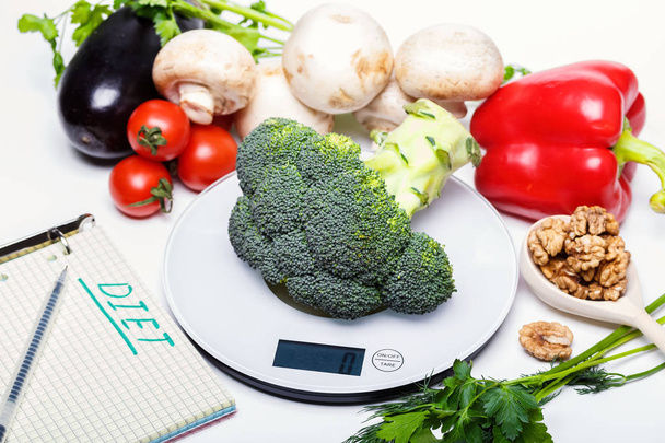 Weigh products on electronic kitchen scales and record the results. The concept of healthy eating, diet, calorie counting, eating restrictions - Photo, Image