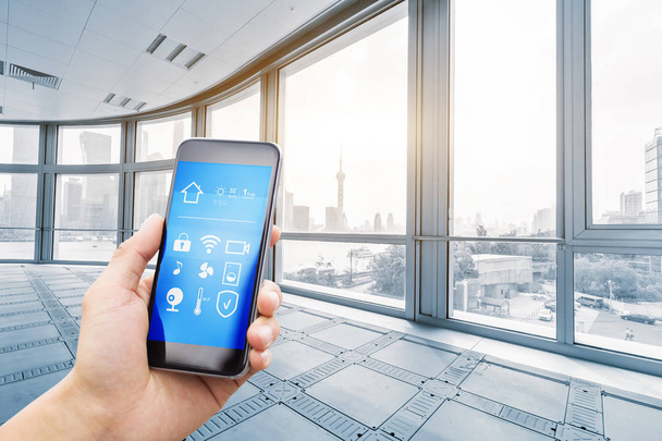 smartphone with smart home and modern office under sunbeam - Photo, Image