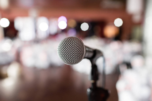 Microphone close-up. Focus on mic. Abstract blurred conference hall or wedding banquet on background. Event concept - Photo, Image