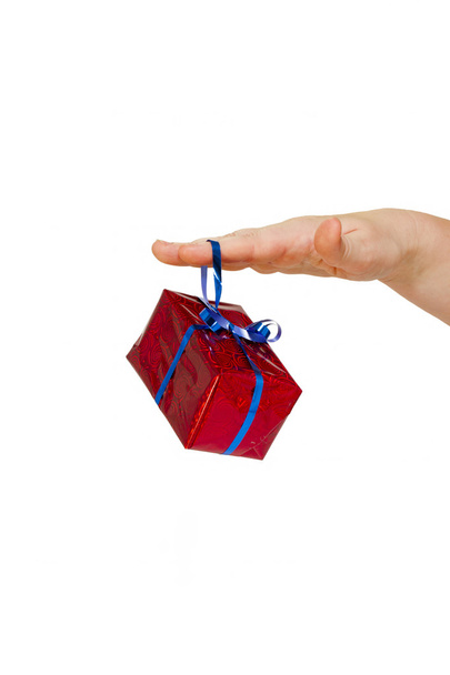 Holiday gift in bright red packaging on a female hand isolated - Фото, зображення