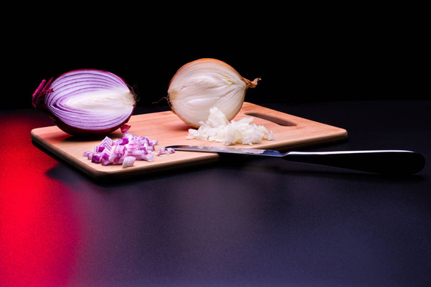 Red and white onion cut and all on a wooden bottom in black background - Photo, Image