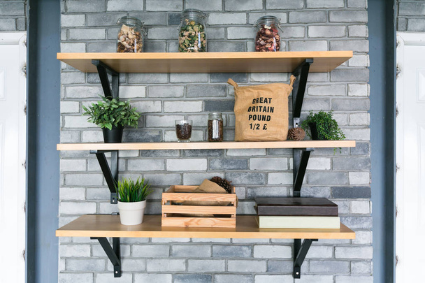 Wooden shelves with different home related objects. - Photo, Image