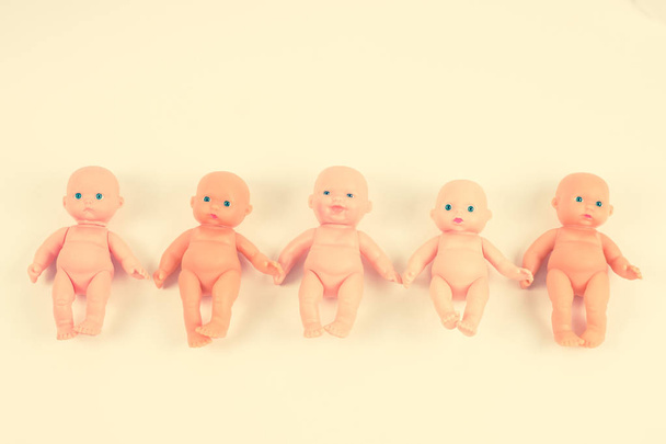 Naked dolls, lined up in a row. Concepts of abortion and childbi - Fotó, kép