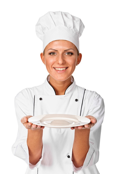 Woman cook or chef serving empty plate and smiling happy - Foto, imagen