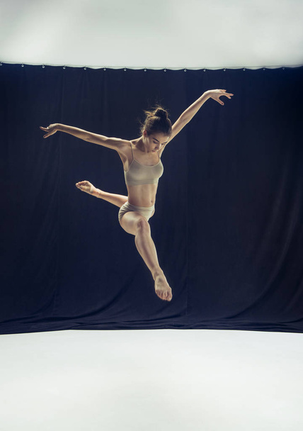Young teen dancer on white floor background. - Photo, image