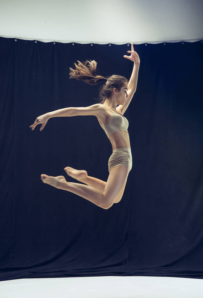 Young teen dancer on white floor background. - Foto, imagen