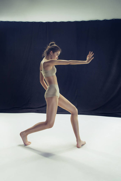 Young teen dancer ion white floor background. - Foto, Imagen