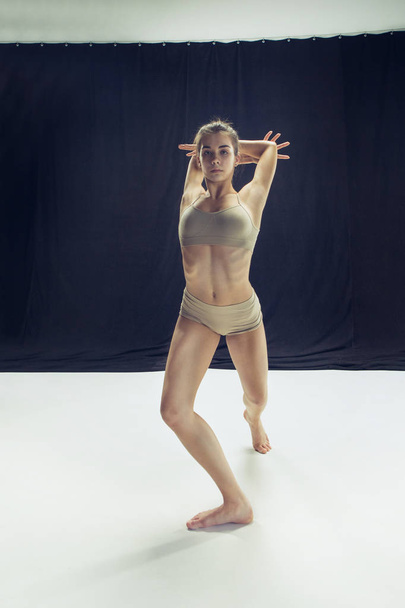 Young teen dancer ion white floor background. - Φωτογραφία, εικόνα