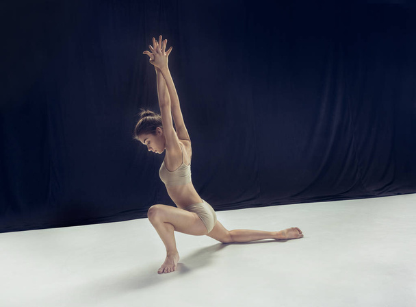 Young teen dancer ion white floor background. - Фото, зображення