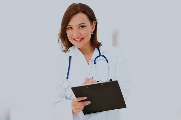 Medical physician doctor woman over blue clinic background. - Foto, imagen